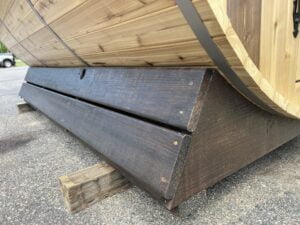 Solid treated wood base for stability