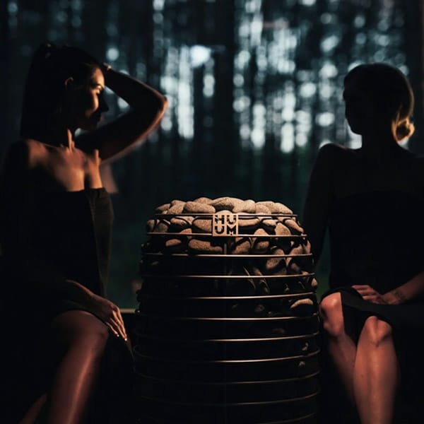 HUUM Hive Mini Wi-Fi electric sauna heater in a modern dark sauna interior