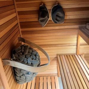 HUUM Drop heater in a modern indoor sauna with ambient lighting
