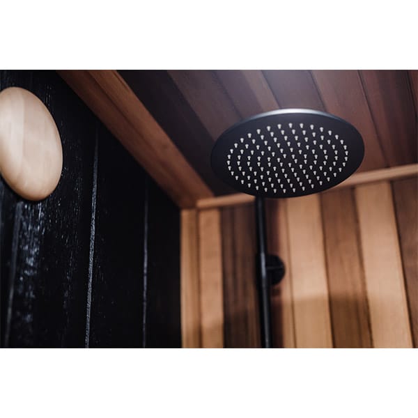 Spacious wooden sauna for six with warm lighting and wellness retreat vibe