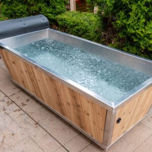 glass front cube sauna reflecting trees