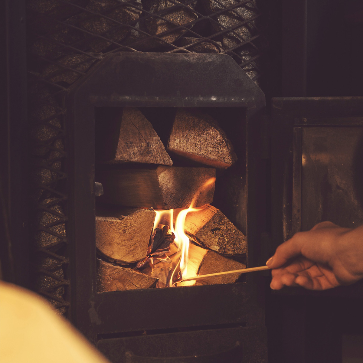 Interior of a triple wood fired sauna with spacious seating and wood burning heater