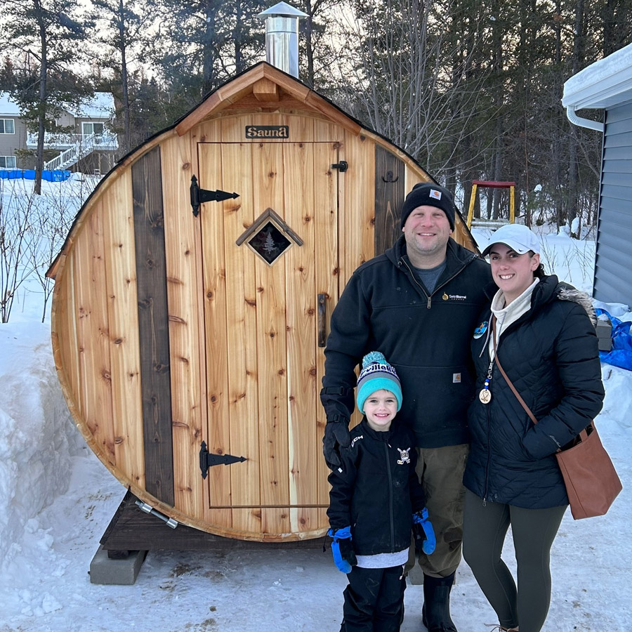 Happy family with their barrel sauna