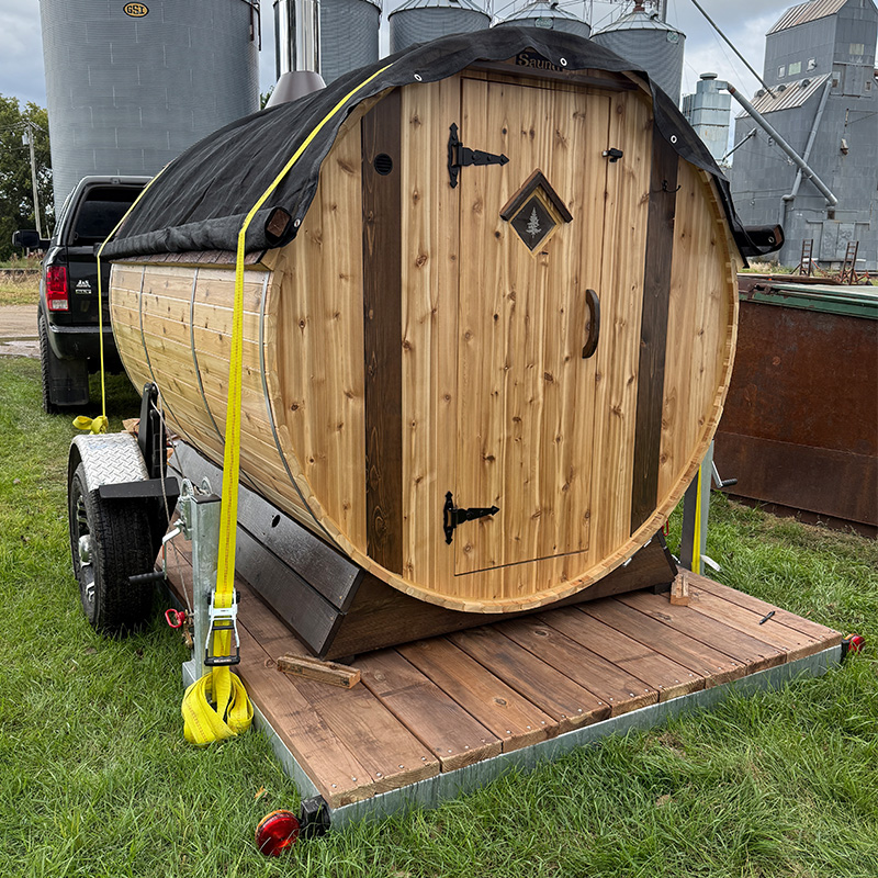 Barrel sauna on trailer dropped down to ground level – easy access and setup