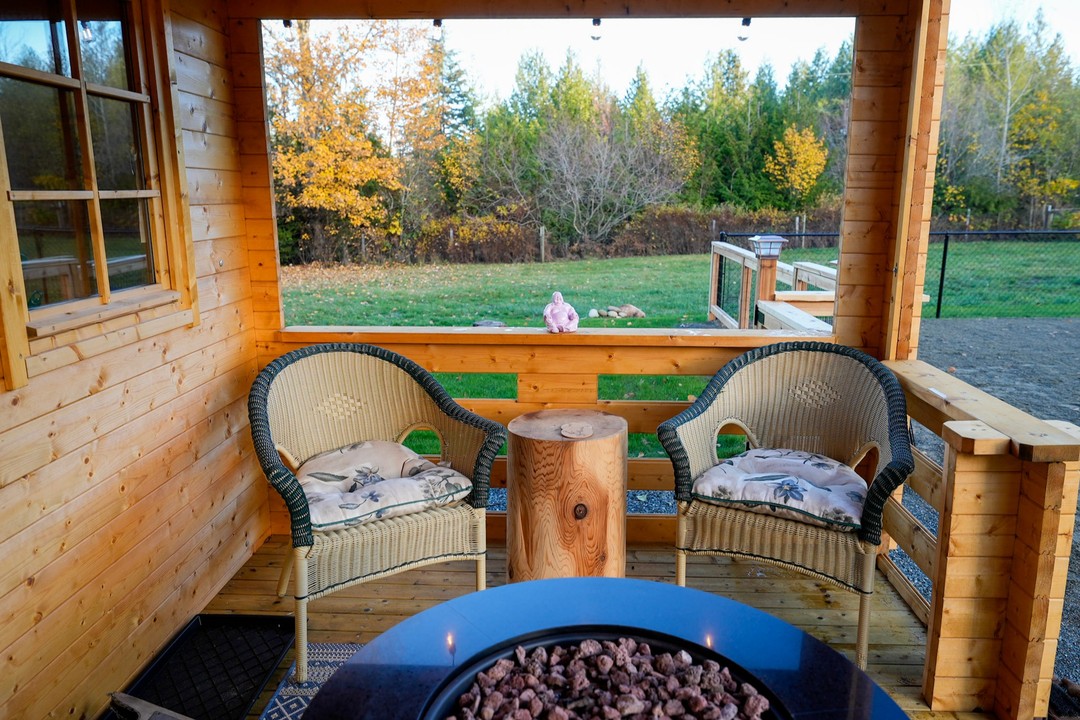 Chairs on the covered porch of the Big Sky Cabin tiny cabin