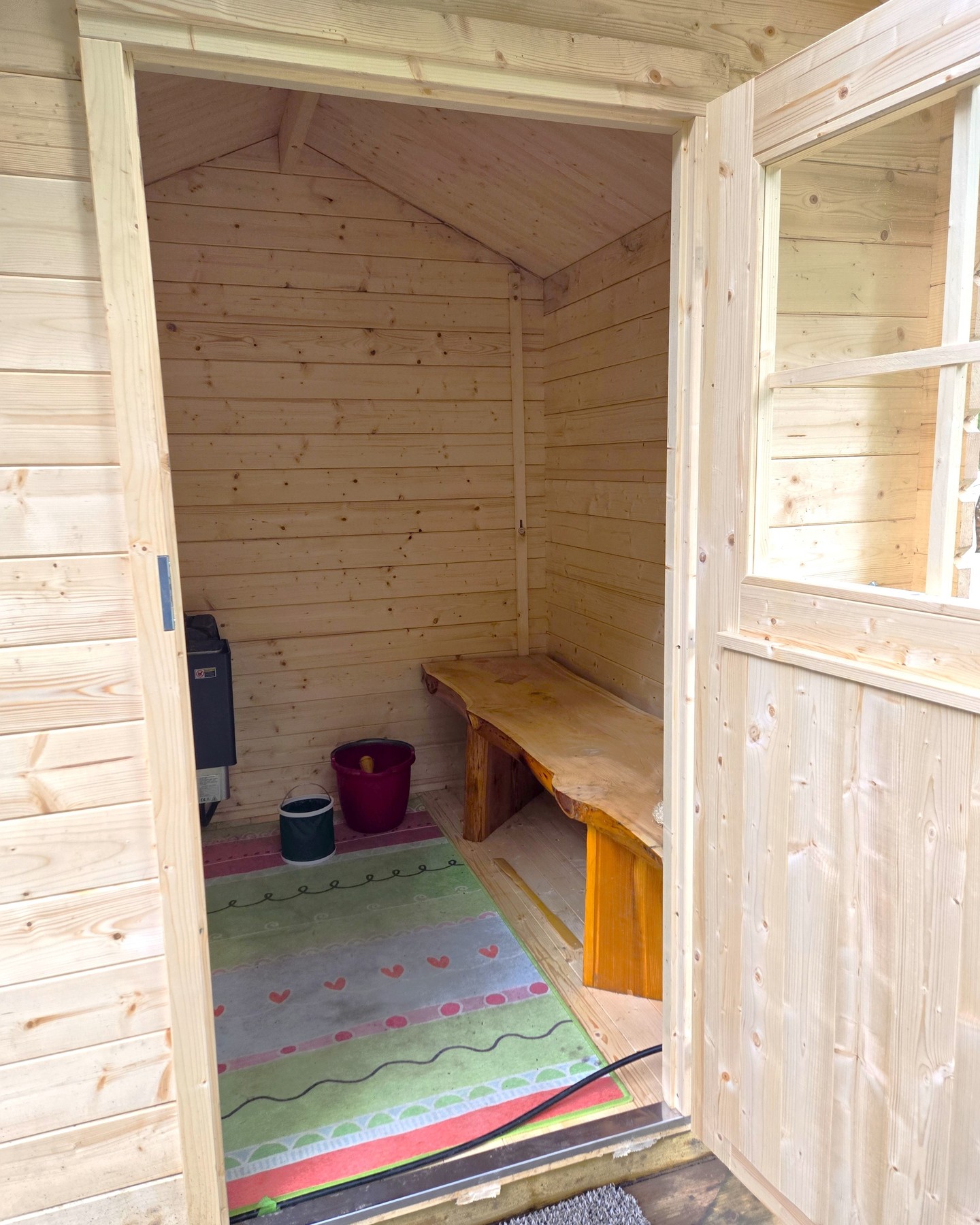 Wooden shed converted into a compact sauna for backyard use