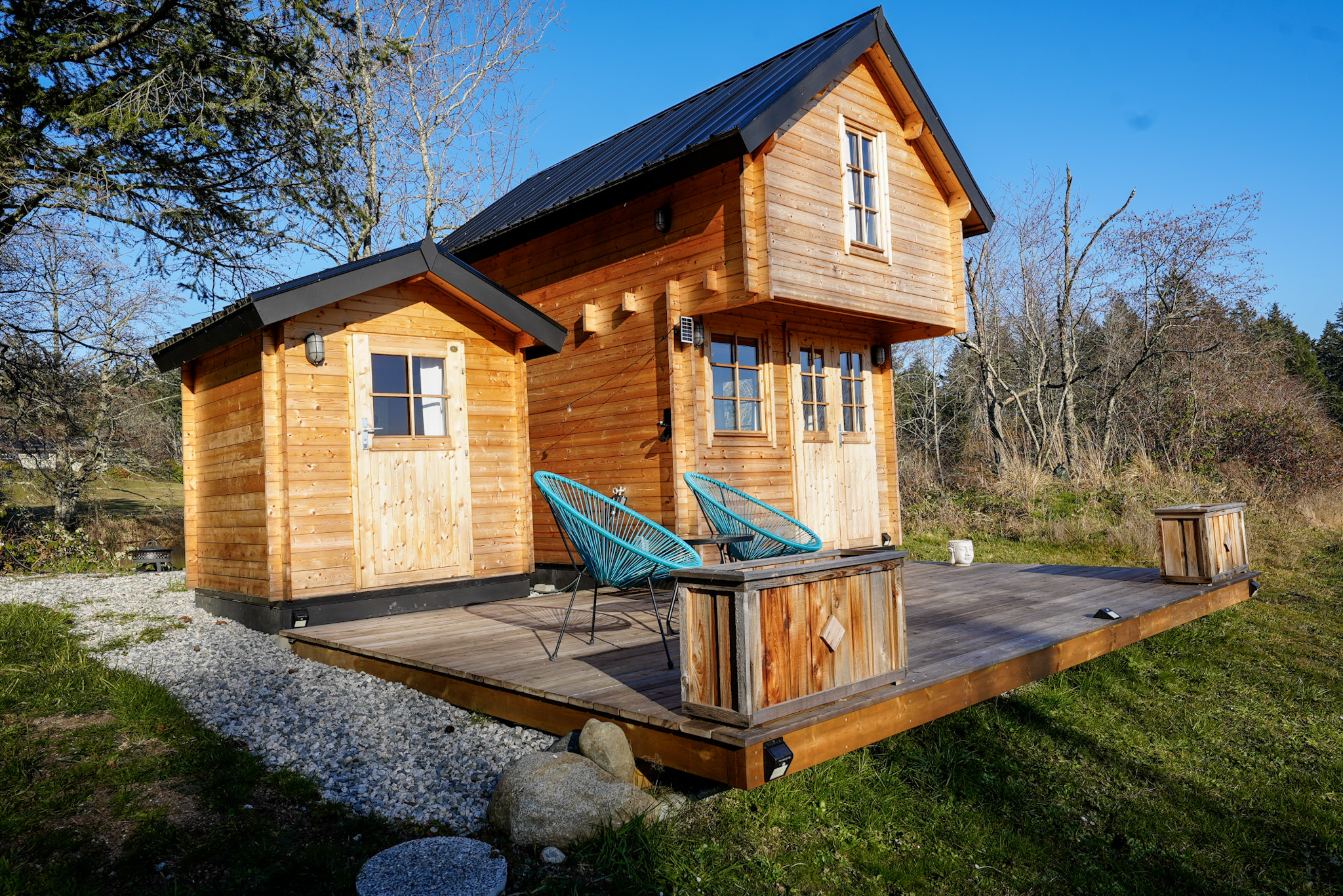 Small shed paired with a backyard bunkie for outdoor bathroom or storage use