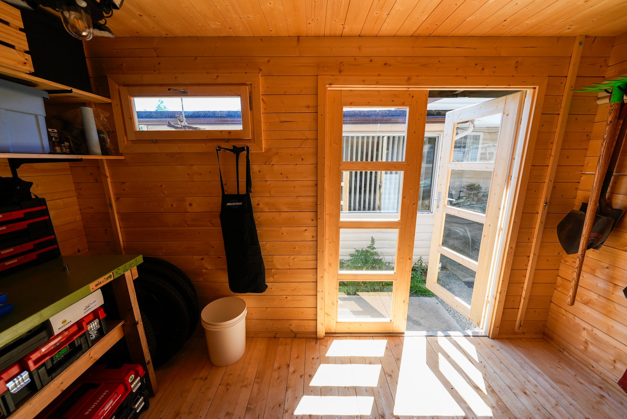 Interior of Independence Studio used as a tool shed with organized tools