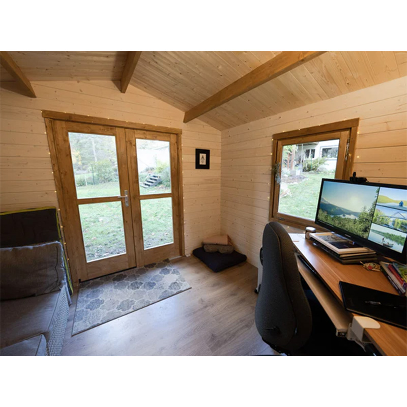 White painted garden shed office interior with couch and work area
