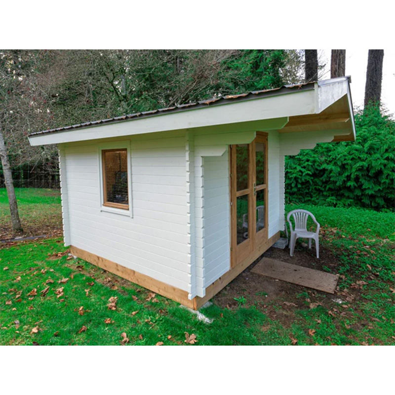 White garden shed office exterior with sweeping roof overhang