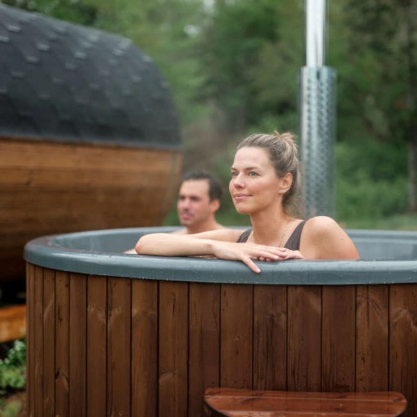 Wood-fired outdoor hot tub in a backyard wellness setting