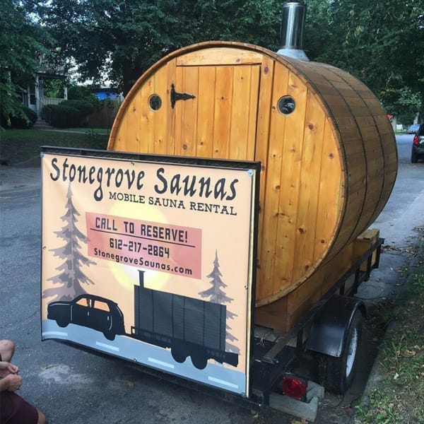 Mobile cedar sauna setup ready for backyard rental or event