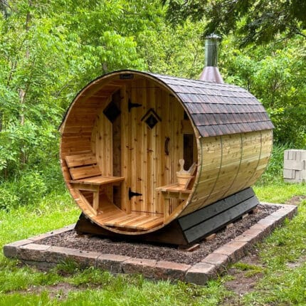 Outdoor barrel sauna handcrafted with Western Red Cedar placed on a trailer in the snow