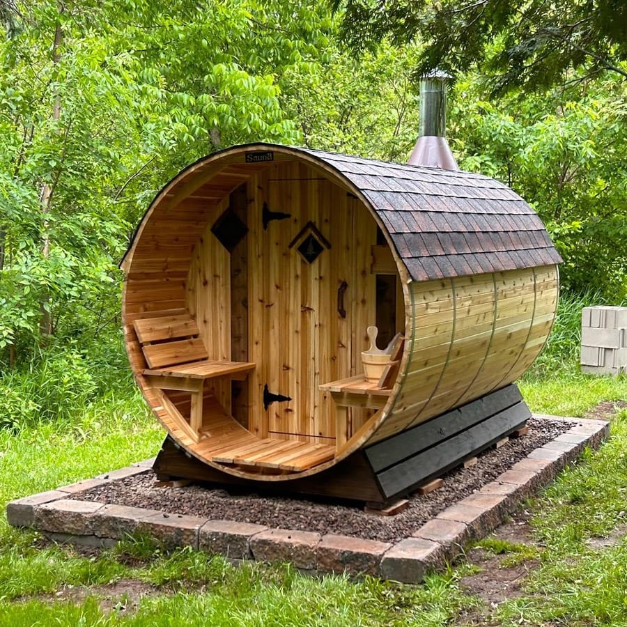 Outdoor barrel sauna handcrafted with Western Red Cedar placed on a trailer in the snow