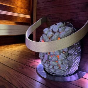 Front view of HUUM Drop electric sauna heater mounted on cedar wall