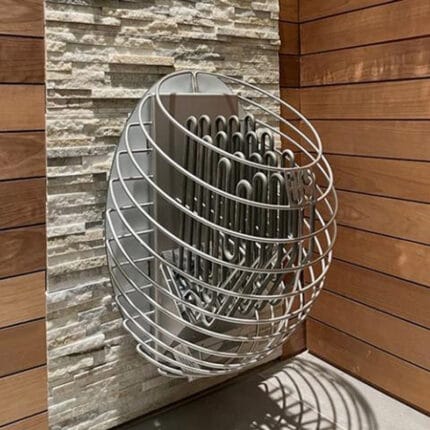 Wall-mounted HUUM Drop heater in a Scandinavian-style cedar sauna