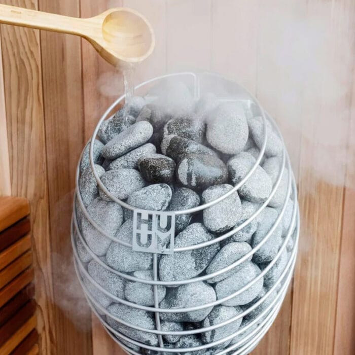 HUUM Drop heater shown in operation inside small home sauna