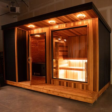 Exterior lighting accents on Cold Creek sauna at dusk