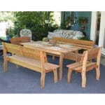 Close-up of bench back and table edge in Cedar Chickadee Dining Set, emphasizing zinc-coated steel and smooth contours in resilient cedar furniture.