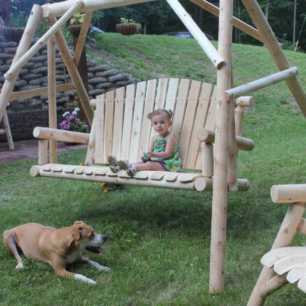 Side view of wood swing set outdoors