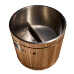 Cold plunge tub situated outdoors showing barrel design