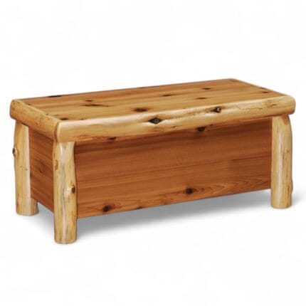 Cedar log blanket chest at the foot of a bed