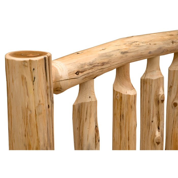 Head-on view of full-size log bed with bedding