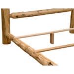 Close-up of vertical log spindles in footboard