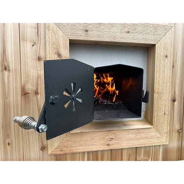 Wood stove inside the sauna with glowing rocks