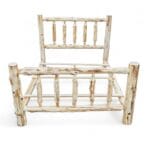 Headboard of unassembled cedar log bed frame with spindle design