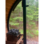 Thermo-Spruce barrel sauna showing durable wood grain and black shingle roof