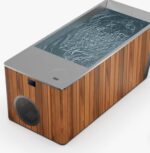 Indoor outdoor cold plunge installed beside a barrel sauna