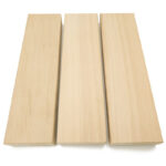 Clear cedar lumber board prepared for sauna bench installation