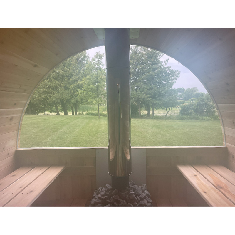 7' x 8' Setri barrel sauna in wooded area with tin roof and porch