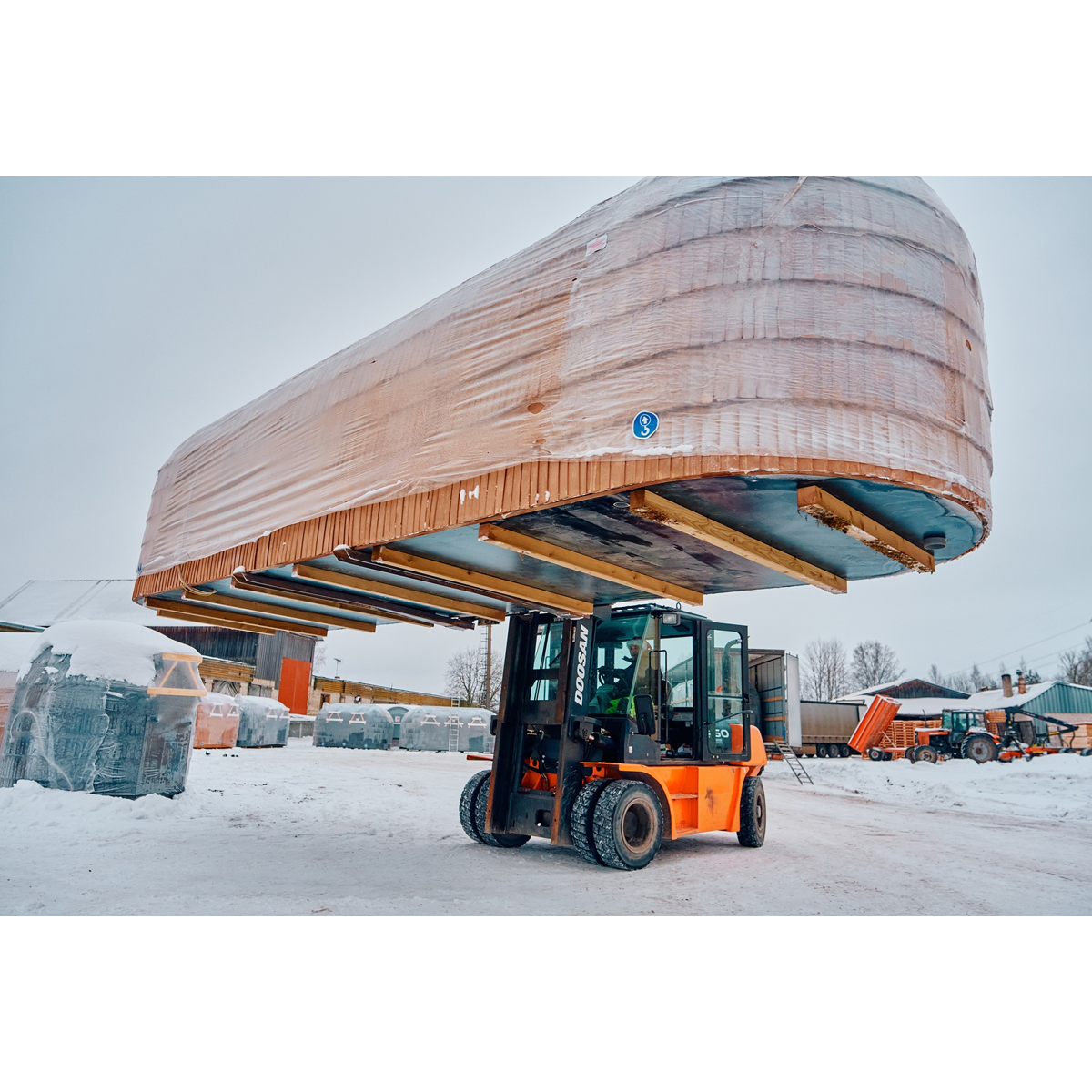 Forklift setting an Iglucraft sauna down at the delivery location
