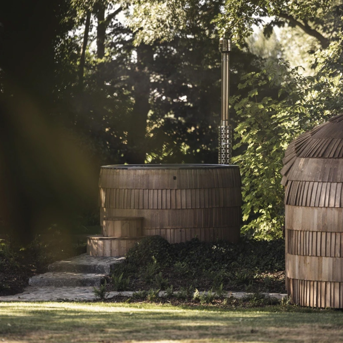 Wood fired hot tub outdoors in black finish