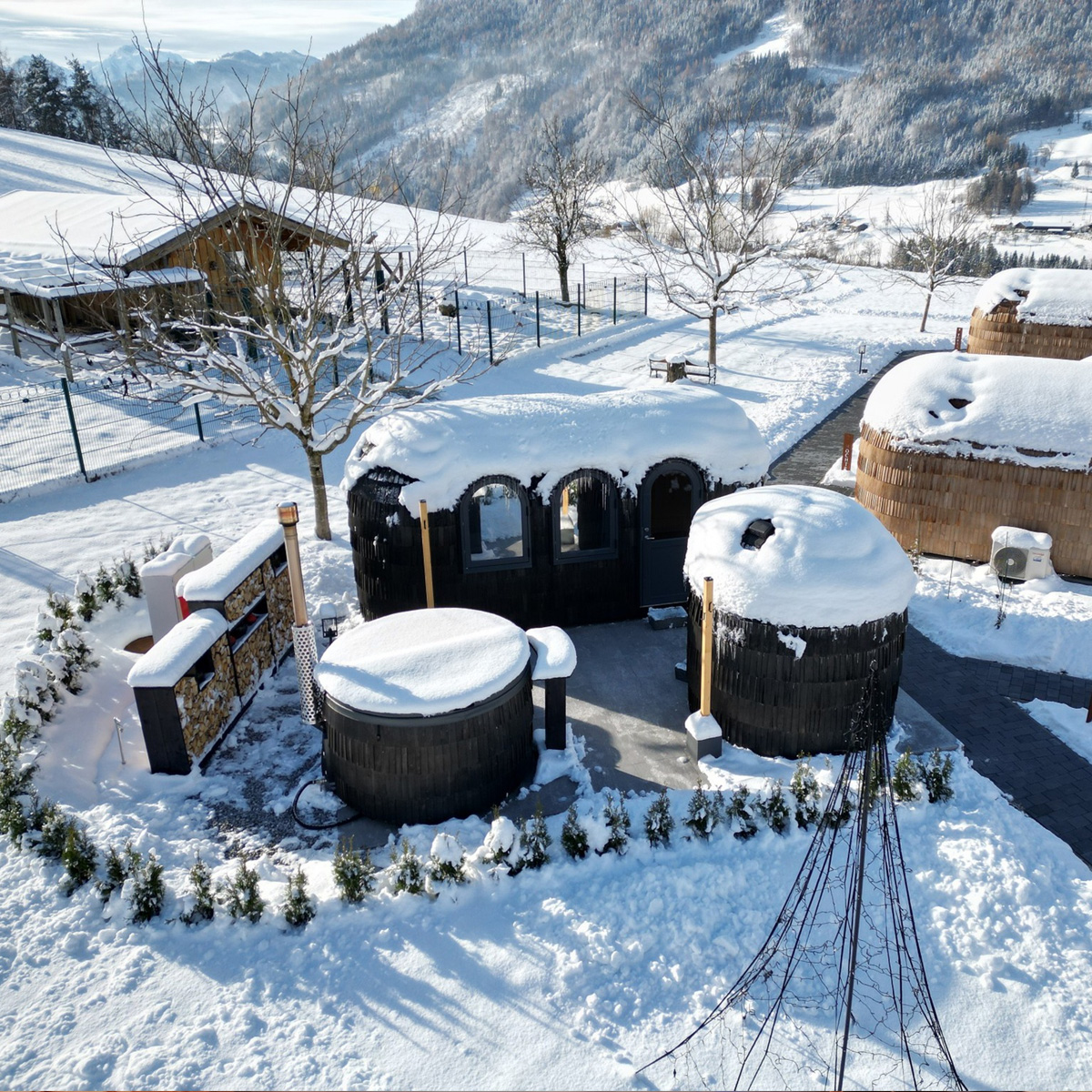 Aerial view of a wood fired hot tub and sauna in the snow