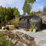 Person entering a wooden sauna