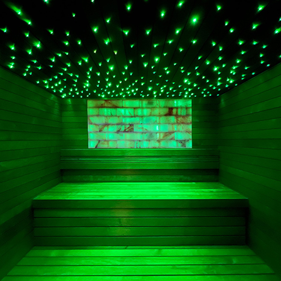 Large Himalayan salt sauna wall lit up with ambient LED lighting for spa ambiance