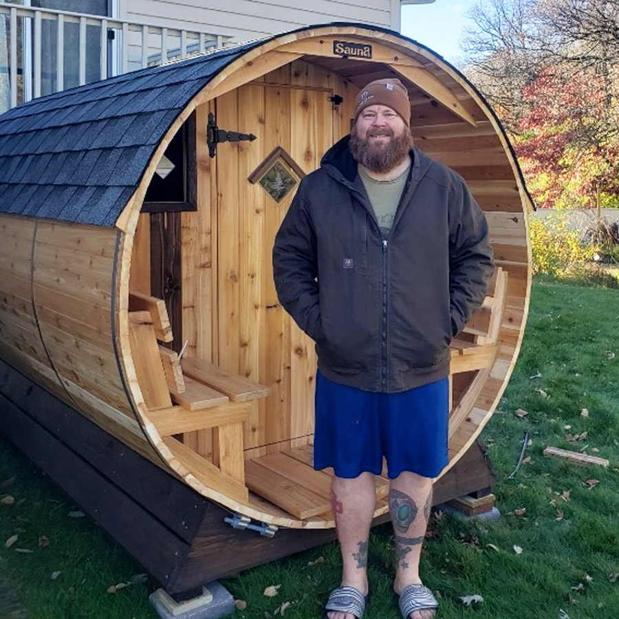 Customer relaxing inside Cedar Sense barrel sauna