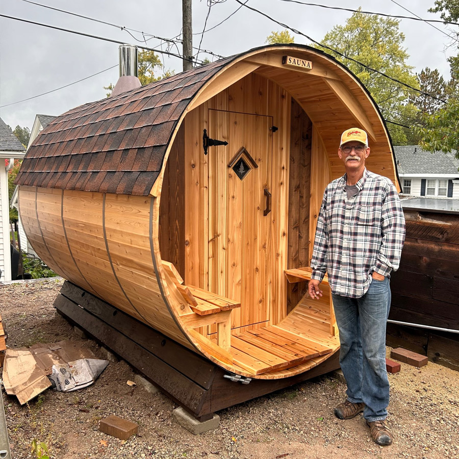 Happy sauna owner with Cedar Sense barrel
