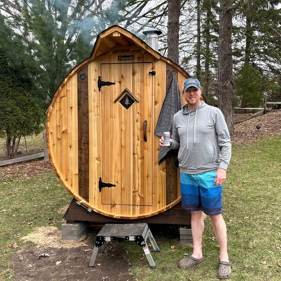 Customer in their new backyard barrel sauna