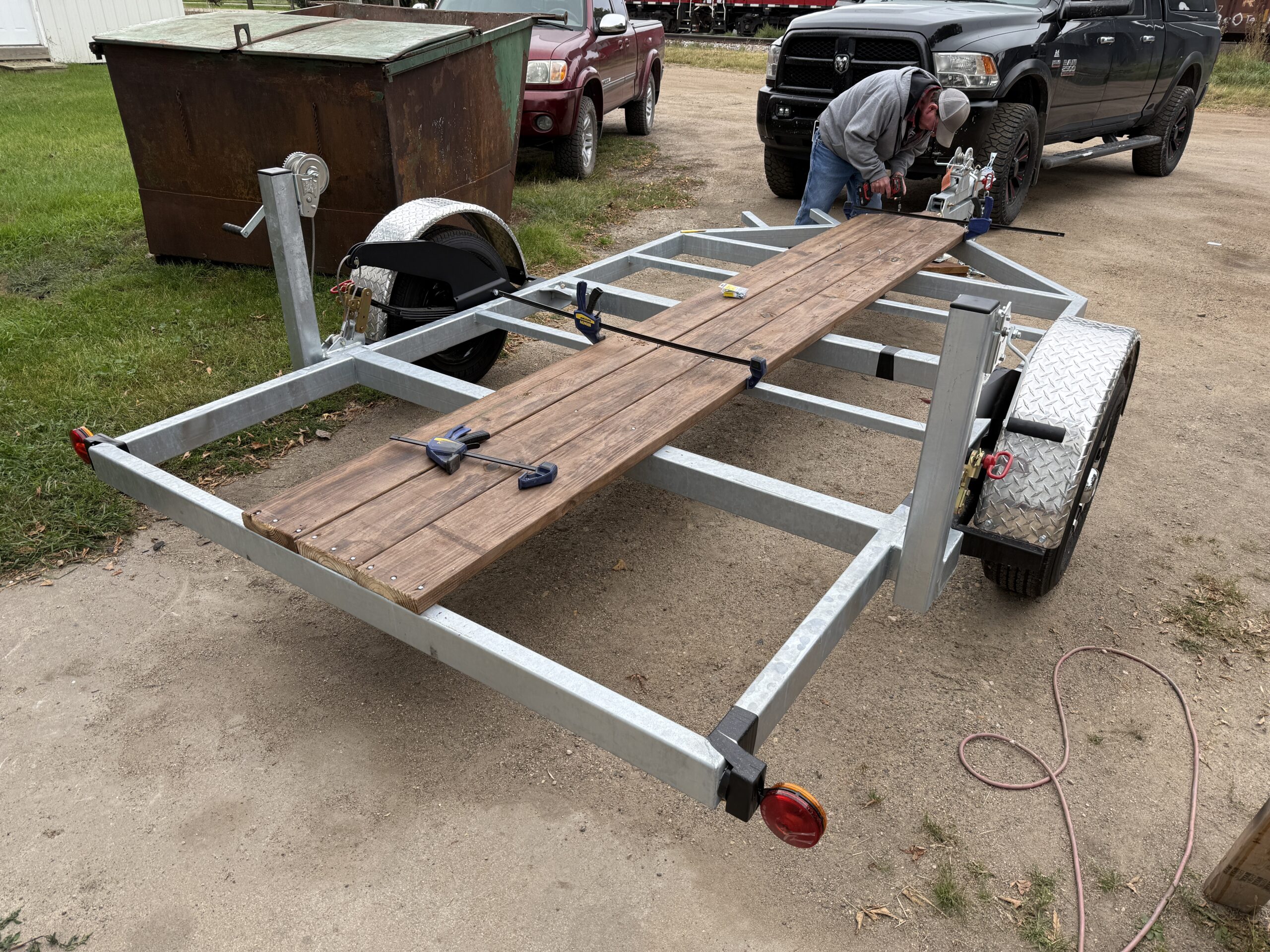 Trailer with partial cedar tone decking installation