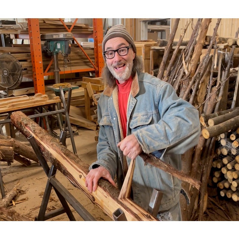 Craftsman hand peeling cedar for rustic furniture