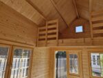 Log cabin kit style bunkie interior with picture window