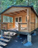Fireplace setup on the covered porch of a tiny cabin