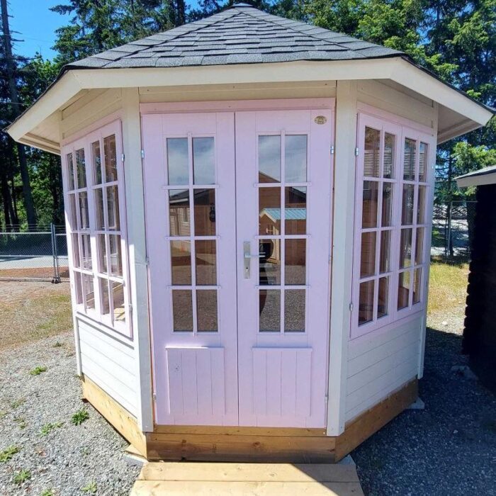 Pink DIY gazebo with white trim for garden retreat