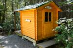 Small outdoor bathroom shed with finished interior layout