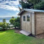 Concrete pad base for wood shed house