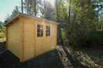 Wooden outdoor storage shed for cabin and rural property use